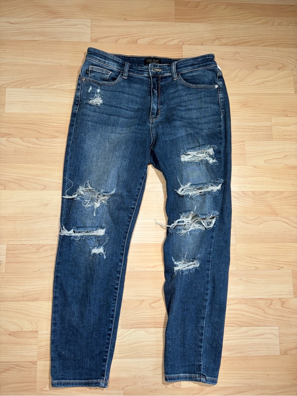 Judy Blue women's distressed boyfriend-fit stretch denim jeans in a medium wash.
